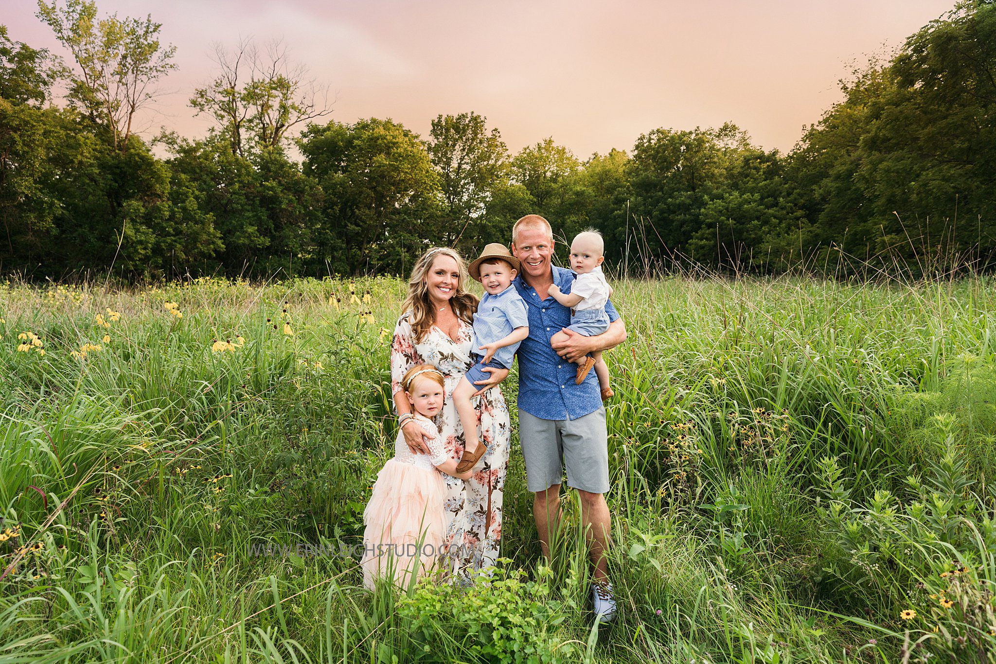 Family standing in a field for family photos