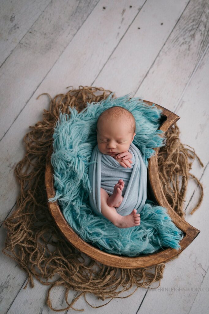 Baby in a moon prop for newborn photography